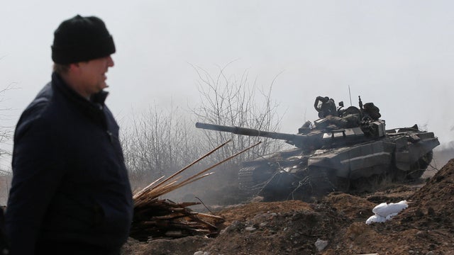 Service members of pro-Russian troops are seen on the outskirts of the besieged city of Mariupol 