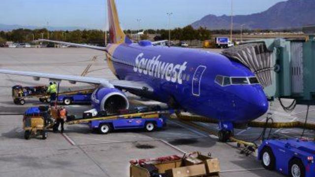Baggage handlers load a Southwest Airlines Boeing 737 passenger aircraft 