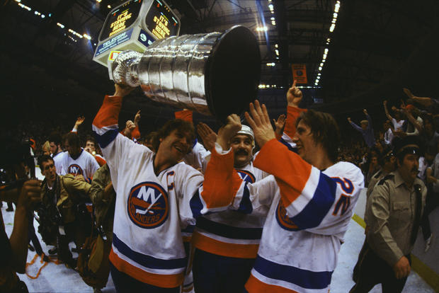 Hockey Players Carrying Trophy 