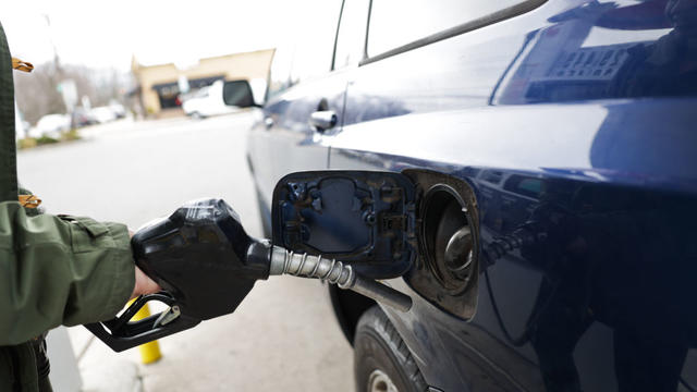 Man Purchases Gas at Pump 