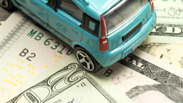 A small car and dollar banknotes 