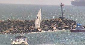2 people rescued after sailboat gets stuck on jetty at entrance of