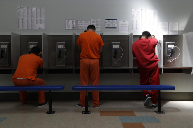 Detainees talk on telephones at the Adelanto ICE Processing Center in Adelanto, California, on Aug. 28, 2019. 