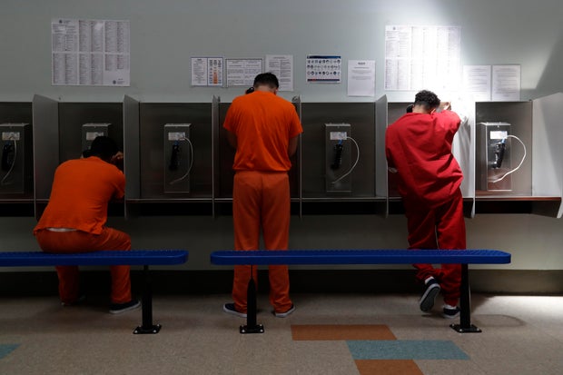 Detainees talk on telephones at the Adelanto ICE Processing Center in Adelanto, California, on Aug. 28, 2019.