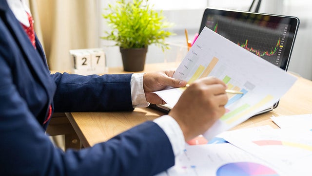 Business owner analyzing sale report and marketing cost for next quarter planning to increase the profit 