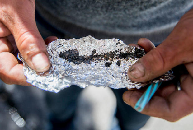 Roger Boyd, 35, holds a piece of foil containing Fentanyl while spending time on McAllister Street in the Tenderloin district of San Francisco, Calif. Friday, June 21, 2019. 