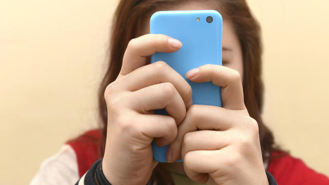 Teenager using her mobile phone 