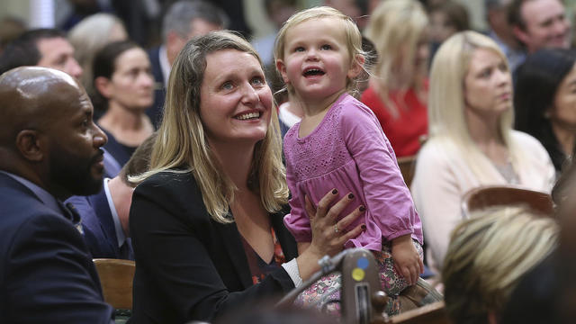 Buffy Wicks holding a toddler 