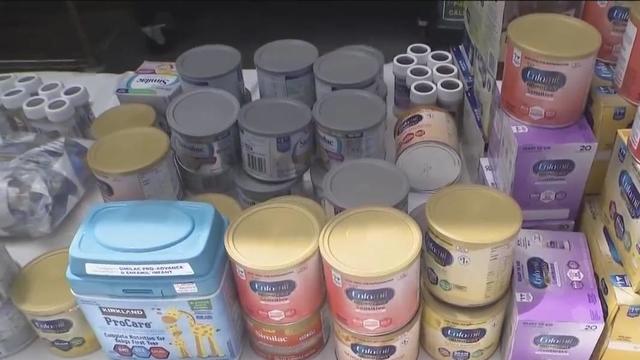 A nearly empty baby formula display shelf is seen at a 