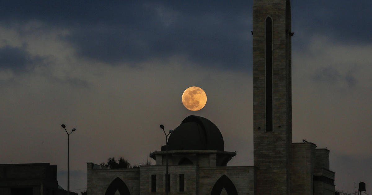 Friday brings a full "Flower Moon" and penumbral lunar eclipse. Here's how to see both.