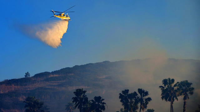 A wind-driven brush fire threatens multimillion-dollar homes in the Laguna Beach 