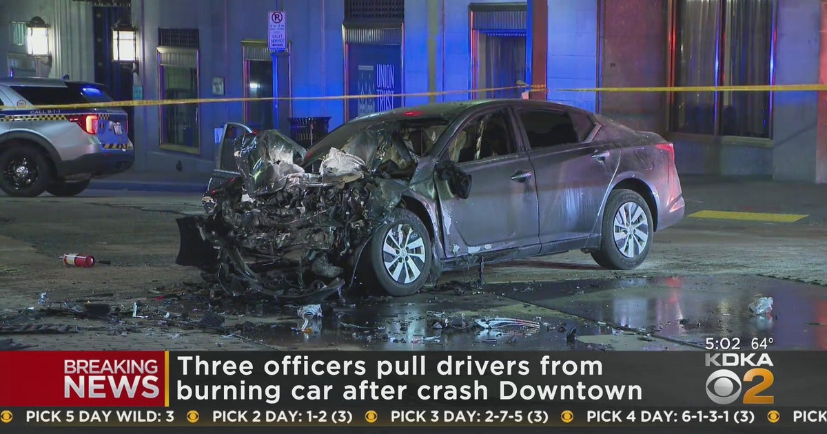 Police officers rescue man from burning car after Downtown crash - CBS ...