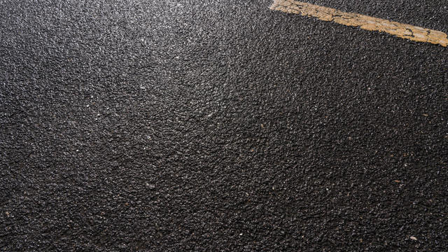 Close up of asphalt road after rain 