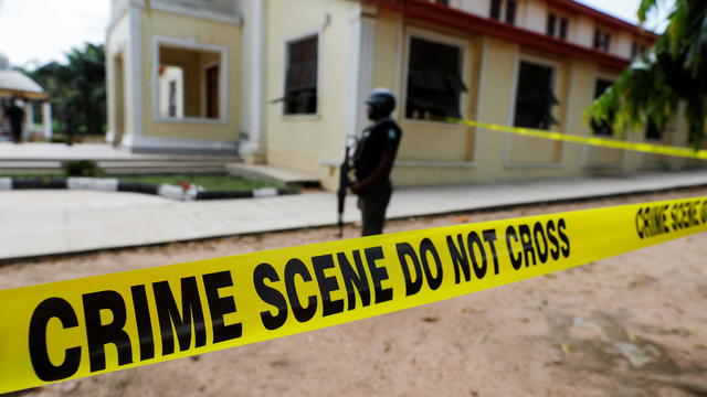 A police crime scene tape is seen in front of St. Francis Catholic Church where gunmen attacked worshippers during a Sunday mass service in Owo 
