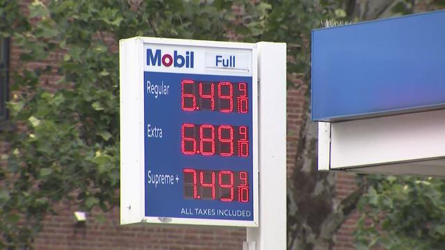 A sign at a Mobil gas station shows the price for a gallon of regular gas is $6.49. 