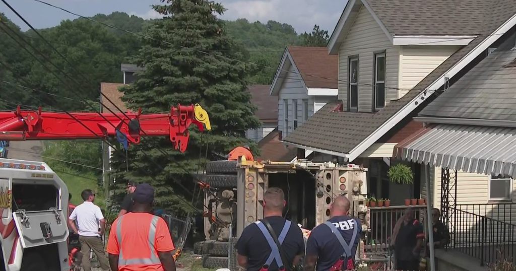 Garbage truck rolls over, crashes into Brighton Heights home CBS