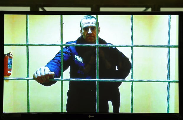 Jailed Russian opposition leader Alexei Navalny attends a court hearing via video link