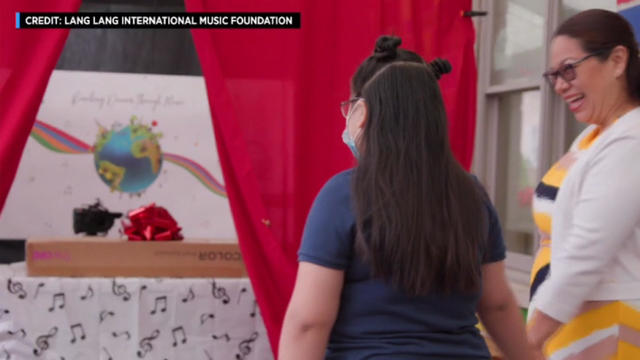 A public school student in Newark is presented with a piano keyboard. 