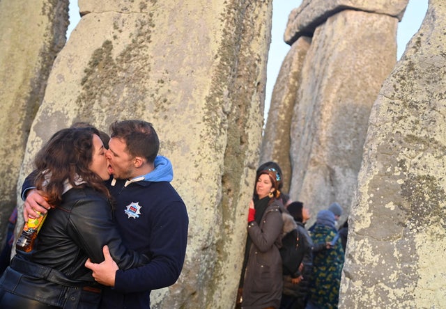 Revellers gather to celebrate the Summer Solstice at sunrise at Stonehenge stone circle near Amesbury 