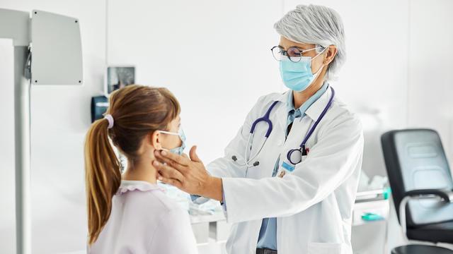 Doctor examining girl in hospital 
