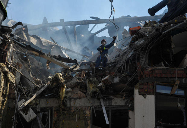 Rescuers work on a damaged residential building, as a result 