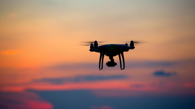 The drone in sunset sky. 