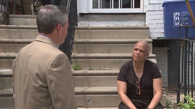 Monique Irvis recalls her son's murder while sitting on the stoop of her Southwest Philadelphia home. 