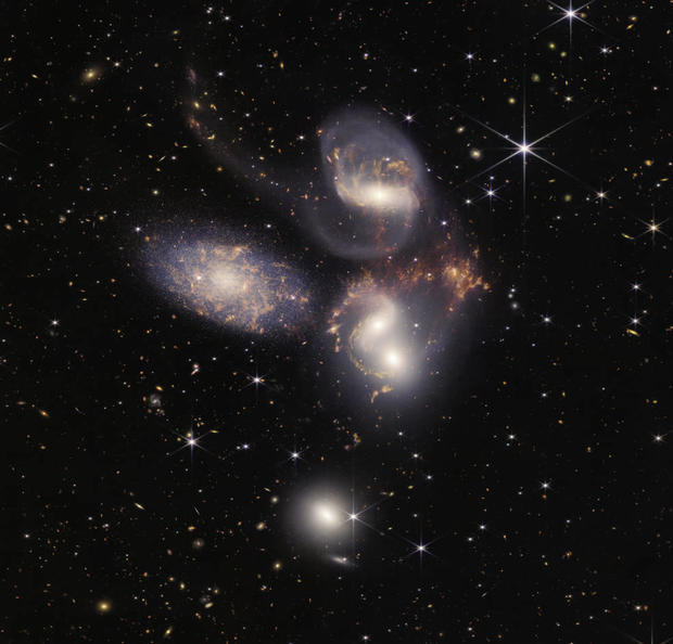 An image taken by the James Webb Space Telescope shows Stephan's Quintet, a galaxy cluster showing huge shockwaves and tidal tails. 
