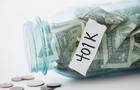 Close up of spilling 401K savings jar 