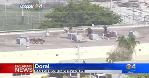 Armed man on roof of Doral building taken into custody after being shot by police