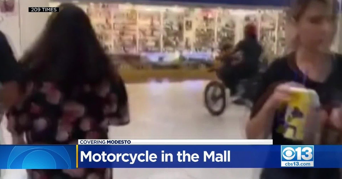 People on dirt bikes ride through Modesto mall