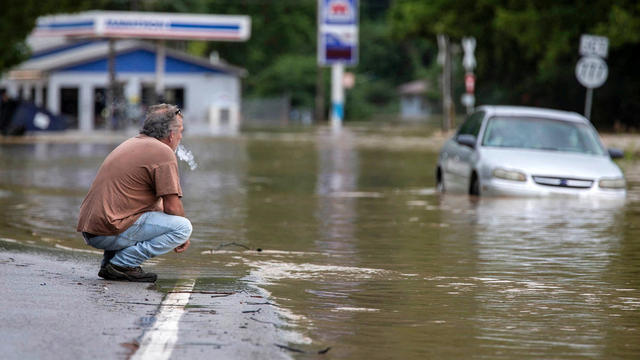 Van Jackson checks on his dog, Jack, who was stranded at a church by floodwaters following a day of heavy rain in Garrett, Kentucky, July 28, 2022. 