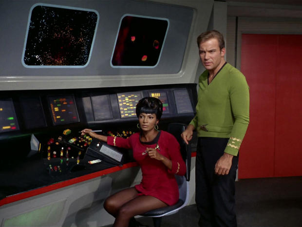 Nichelle Nichols as Uhura and William Shatner as Captain James T. Kirk in a scene from "Star Trek" 