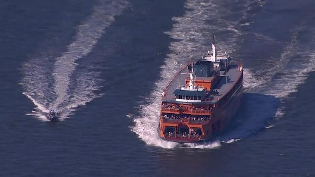 A Staten Island Ferry crosses the river. 