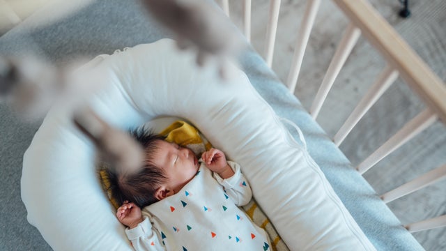 Cute Asian Baby Sleeping In Crib 