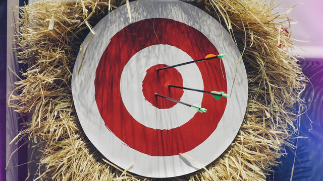 Close Up Of Arrows On Target Over Bale 