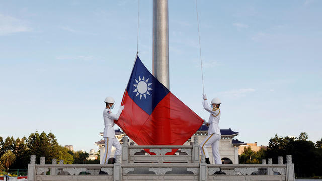 FILE PHOTO: Honour guard members take part in a flag-raising ceremony in Taipei 