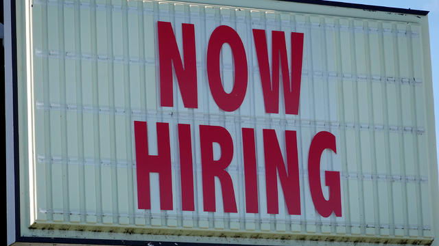 A Now Hiring sign hangs in front of a Winn-Dixie grocery store on December 03, 2021 in Miami, Florida. 