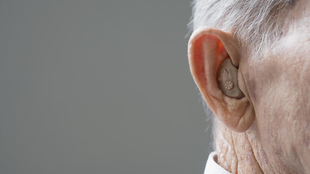 Close up of senior Hispanic manÂ¿s hearing aid 