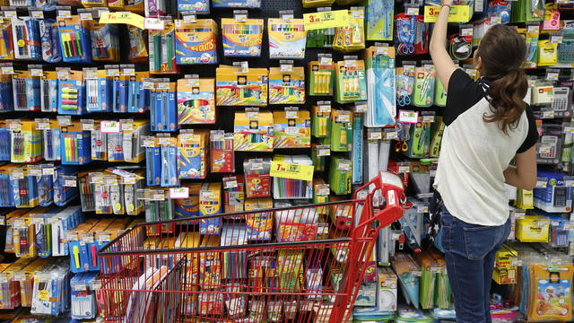 Teenager shopping for school supplies in a supermarket 