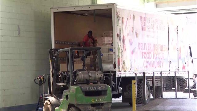 A Campaign Against Hunger worker loads a truck. 