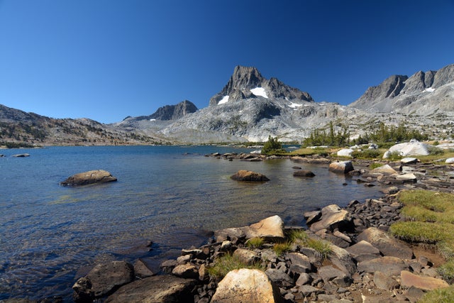 Mighty peaks above a beautiful blue alpine lake. 