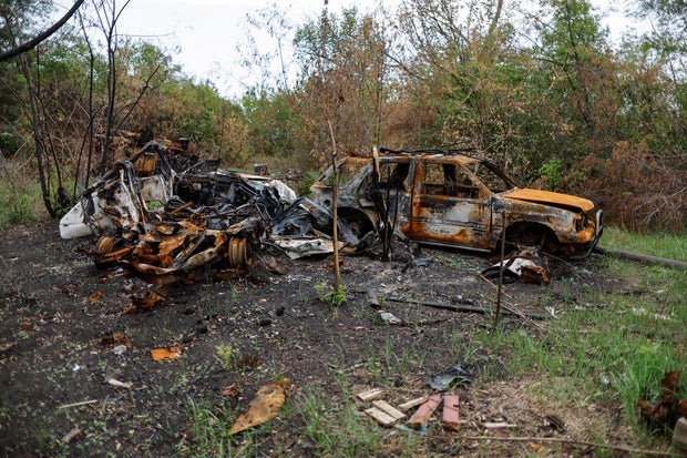 Burned-out cars are seen near Bakhmut, in eastern Ukraine, as Russia's attack on the country continues Aug. 20, 2022.