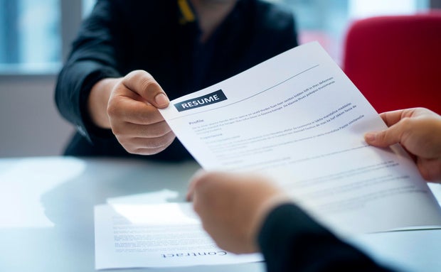 Recruitment, Job application, contract and business employment concept. Hand giving the resume to the recruiter to review the profile of the applicant. 