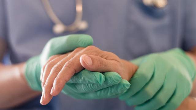 Surgeon, physician performs surgical operations, anesthetist or anesthesiologist holding patient's hand ffor checking state of mand or support in ER room, Medical healthcare concept 