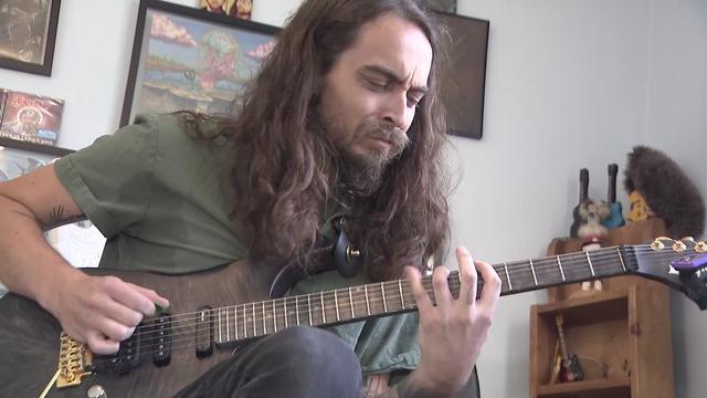 Moon Tooth guitarist Nick Lee plays a guitar. 