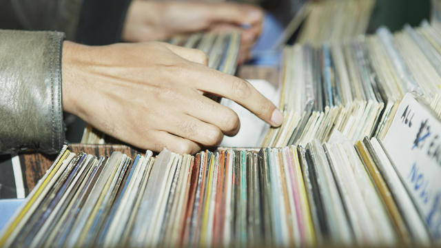 CU on hands searching through vintage records 