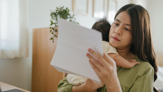 Mother managing home finance. 