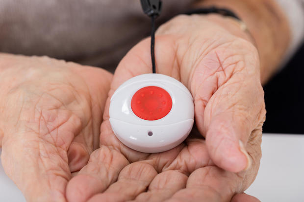Senior woman holding an alarm button 