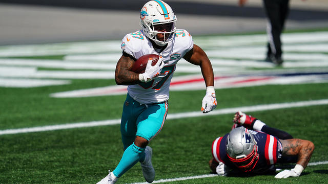 Miami Dolphins running back Myles Gaskin, left, is tackled by New England  Patriots cornerback Joejuan Williams, right, during the second half of an  NFL football game, Sunday, Sept. 12, 2021, in Foxborough